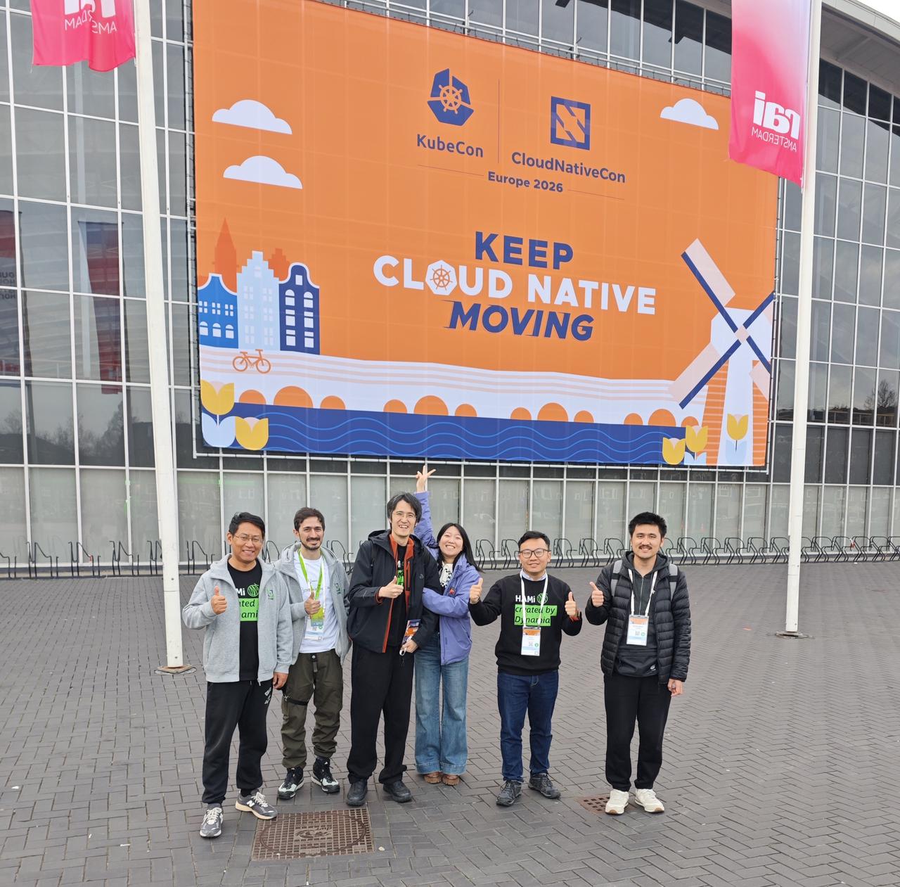 The Dynamia team with community members outside the KubeCon venue